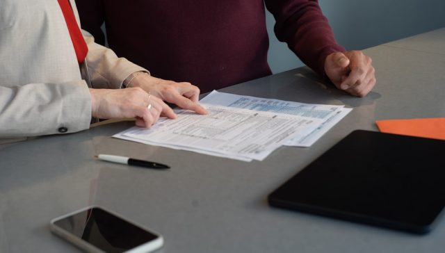 Business professionals reviewing commercial contract documents