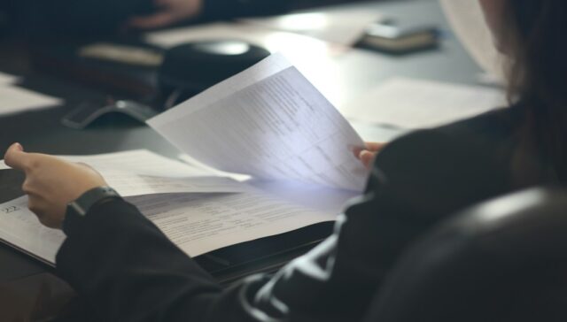 Professional reviewing legal documents for a UAE arbitration clause and enforcement article